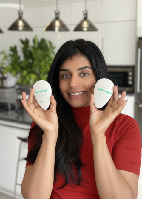 Woman showing off two BanishBugs devices in kitchen